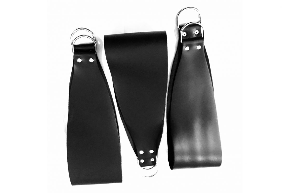 Set of three black leather stirrups with D-rings, on a white background